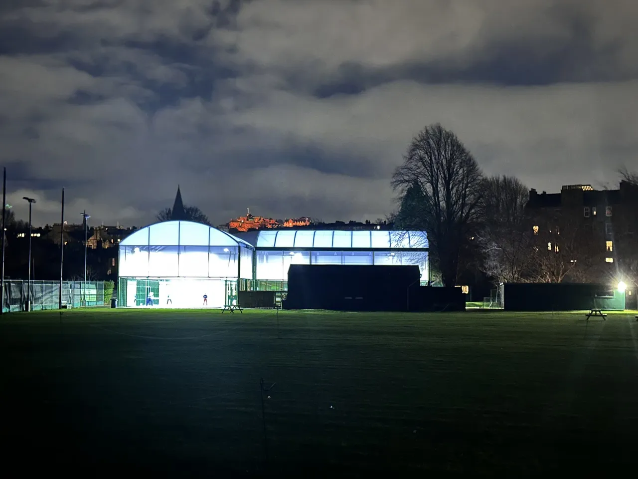 The Grange Club padel courts at night, Edinburgh Castle visible in the background